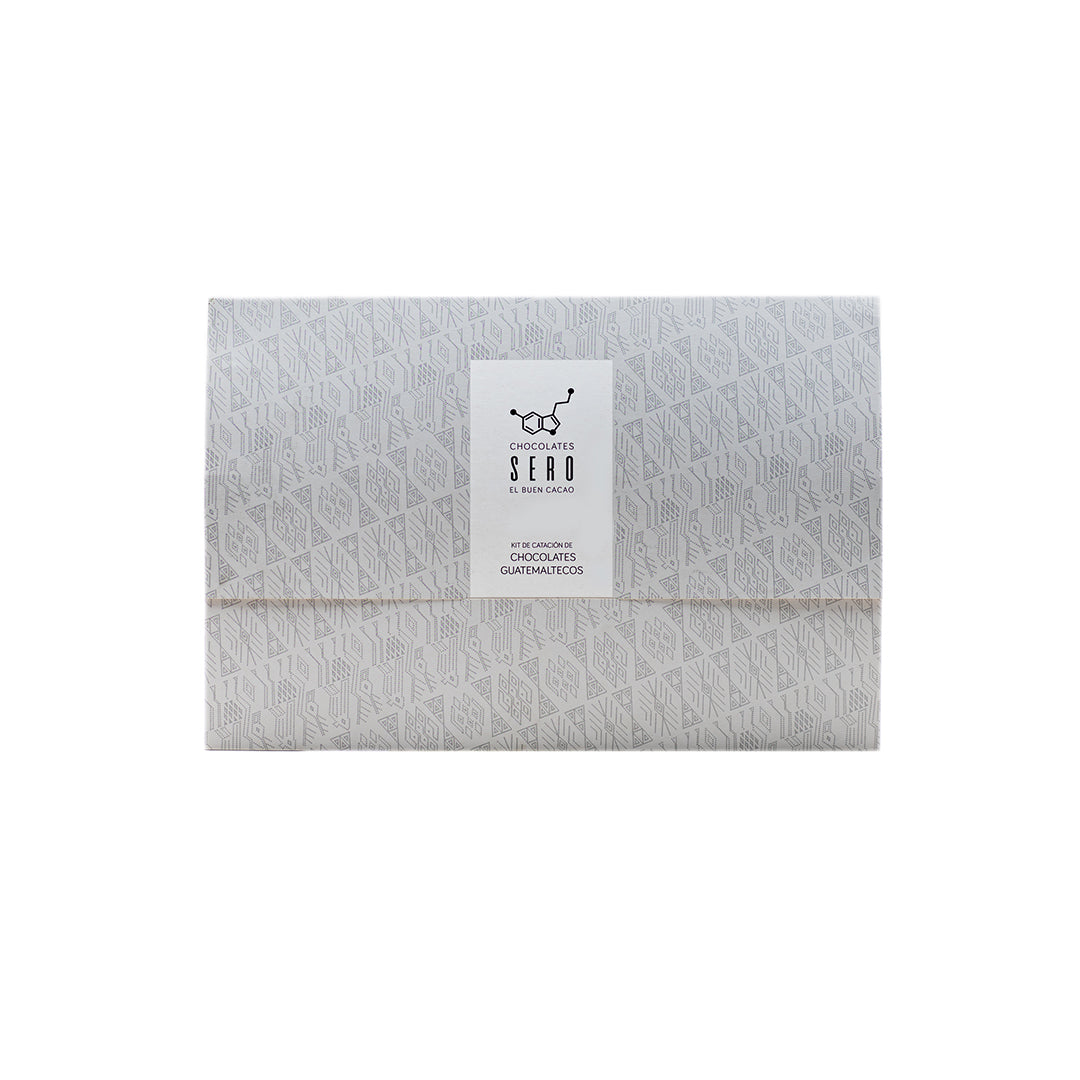 Chocolates Sero Tasting Kit featuring four 70% dark chocolate bars from distinct Guatemalan origins, a printed tasting mat, and a QR code linking to a video guide on how to taste chocolate. Designed for immersive, educational, and ethical chocolate exploration.